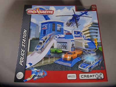 toys are in a box on a table in front of a building