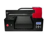 a black and red printer sitting on top of a white surface