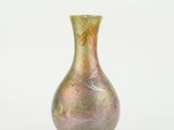 a small vase that is sitting on a white surface