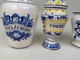 three blue and white vases sitting next to each other