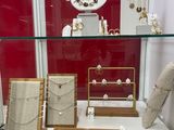 a display case with many different types of jewelry on it