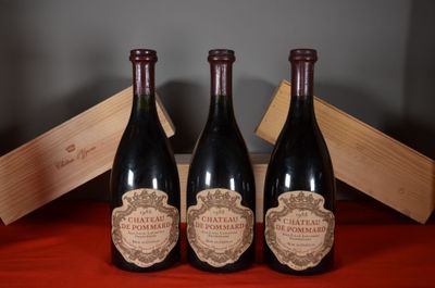 three bottles of wine are sitting on a table with a wooden box