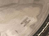 a close up of a silver plate with writing on it