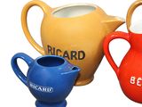 three different colored jugs sitting next to each other