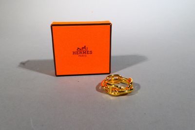 an orange box with a gold ring sitting on top of it