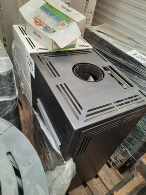 a microwave sitting on top of a pallet in a room