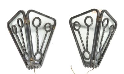 four pairs of scissors hanging from the side of a wall