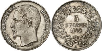 a silver coin with the head of a man in profile