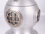 a metal object that is sitting on a white surface