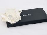 a black box with a white lace bow on top of it