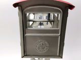 a metal mailbox with a red top on a white background