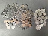 a bunch of coins sitting on top of a table next to each other