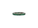 a close up of a ring with emerald stones on a white background