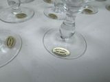 many wine glasses sitting on a table with labels on them