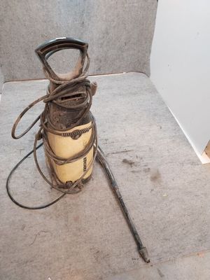 an old iron canister sitting on the floor next to a hammer