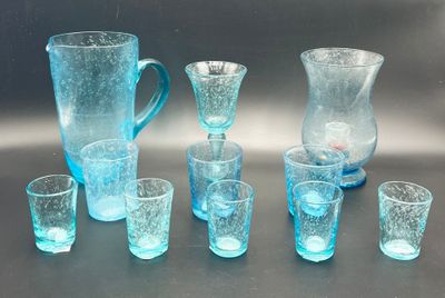 bottles and glasses are lined up in a row on a table