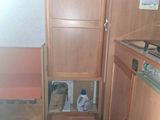 an image of a small kitchen with a sink and cabinets