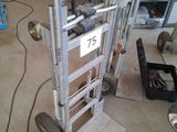 a hand truck with a sign on it in a garage