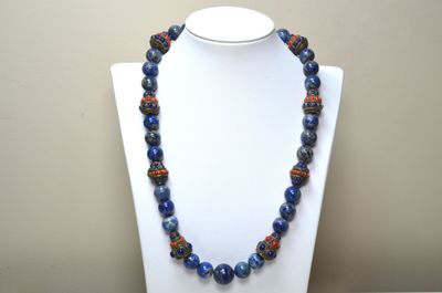Un collier composé de boules de lapis lazili et de motifs en…