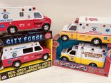 three toy ambulances that are sitting in a box