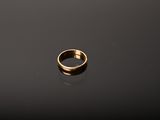 a gold ring sitting on top of a black surface