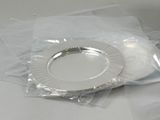 a silver plate sitting on a plastic bag on a table