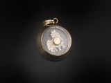 a close up of a gold locke with a coin on it