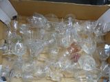 a box full of empty wine glasses sitting on a table