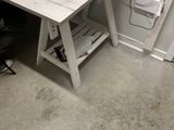 a desk with a laptop and a printer on it