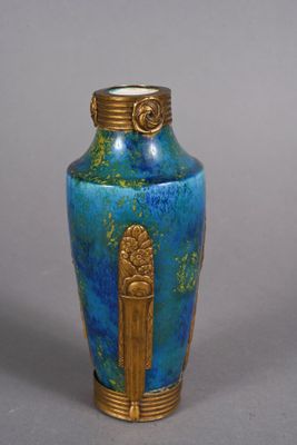 a blue vase with a gold decoration on it