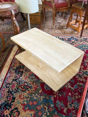a coffee table that is sitting on a rug in a living room