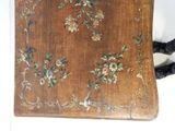 a small wooden box with a floral design on it