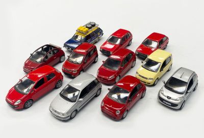 several toy cars are lined up in a row on a white surface