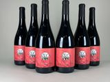 six bottles of red wine are lined up in a row