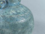 a blue vase that is sitting on a table