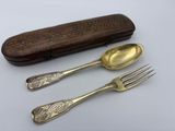 three forks and a spoon sitting on a table