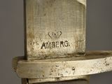 a close up of a knife on a wooden stand