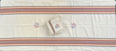 a white blanket with a red and blue design on it