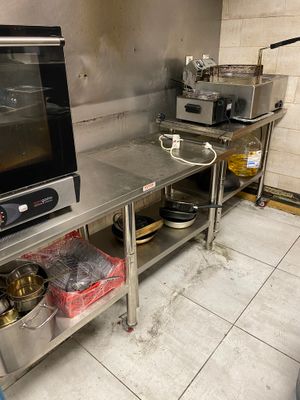 a kitchen with a stove, oven, sink, and other items on the counter