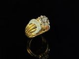 a gold and diamond ring on a black surface
