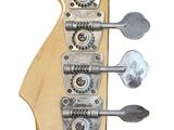 the headstock of a guitar with a wooden body and four metal knobs