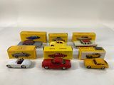 several toy cars are lined up in a row on a white surface