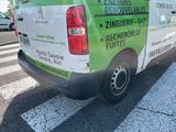 a green and white van parked on the side of the road