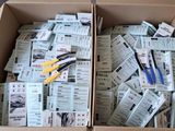 a box full of tickets and scissors sitting on the floor