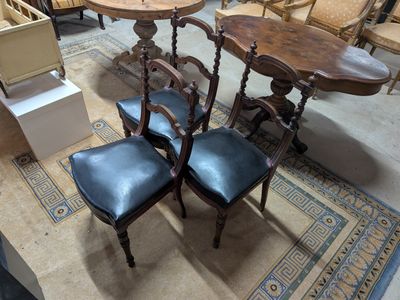 three chairs and a table in the middle of a room