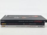 three books are stacked on top of each other on a white surface