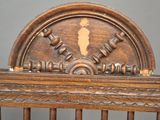 a wooden chair that has a clock on the back of it