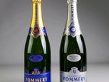 two bottles of champagne sitting next to each other on a table