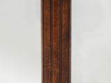 a tall wooden pole with a clock on top of it