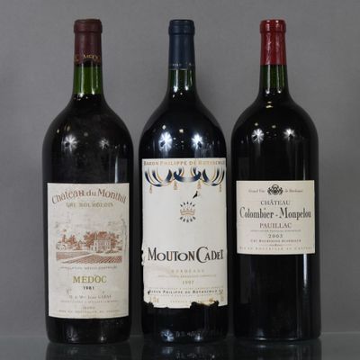 three bottles of wine sitting on a glass table